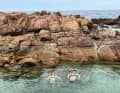 The crew uses the delay in clearing out for shore leave; swimming ...