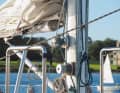The halyard winches are mounted on the mast, where the crew is held by brackets