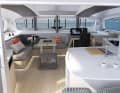 The galley on the aft cabin bulkhead functionally links the saloon with the outside cockpit. The navigation is built at the front of the wide window front.