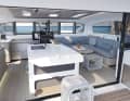 The multifunctional kitchen island in the transition from the saloon to the exterior cockpit is a dominant feature.