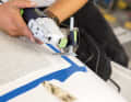 An oscillating saw is then used to cut through the approximately four millimetre thick outer laminate all the way to the core