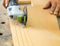 ... slit from below. The depth stop of the oscillating saw is set to three quarters of the material thickness. The cuts follow the outer contour of the panel