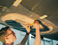 A template is made from foil to cut the glass scrims to size. Mark the outer contour and the shape of the hole to determine the largest and smallest layer of scrims