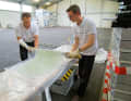 ... is placed on top. The resin is worked in with a spatula until the glass is transparent. The largest flap is on top and thus lies directly against the fuselage; the repair area is covered with continuous fibres