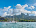 Below, the "Lady Charlyette" anchors off Hakahau on Ua Pou, with Mont Oave in the background