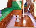 The high-quality teak interior harmonises with the green upholstery