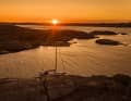 Everything done right: Our boat in front of a marvellous sunset on the rock of the island of Uleholmen at the beginning of the Oslofjord.