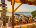 Relaxed evening atmosphere on the terrace of the Quai 58 bar on the Grand Case bay.