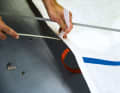 Relax the sail battens or, better still, take them out completely. Then the cloth can be folded and packed much smaller