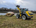 The ship was pulled ashore with a yellow wheel loader