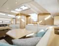 The interior offers a U-shaped sofa and a dinette opposite.