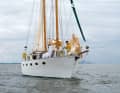 The owner built the schooner rig from wood to match the clipper bow. The high hull with the flat deckhouse looks indestructible and seaworthy