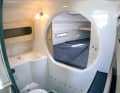 There is a triangular berth in the foredeck, which can be separated by a sliding door. If you want to go there, you have to walk through the wet room