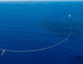 Two ships tow the net slowly