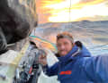 Sam Goodchild has started trying to repair his mainsail, which was torn at the third reef.