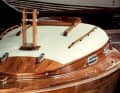 The dinghy cruiser has a varnished running deck made of solid mahogany and a cabin superstructure planked with softwood and then covered with canvas and painted white