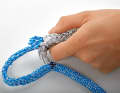 Pull the tapered cover into the core with the splicing needle. For very rigid braids, the end may need to be fanned out a little so that it fits better around the needle and slips through the core