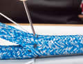 ... optimally. Insert the needle into a yarn crossing and let it come out on the other side exactly between the yarns. For the next stitch, use the needle to pull the top layer of yarn of the sheath braid towards the ...