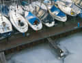 Lined up in rows: boats left on land with their rigging in place during frost – common practice abroad