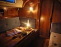 A cosy atmosphere: outside, the rain lashes horizontally across the deck; inside, the paraffin lamp provides a pleasant glow and warmth