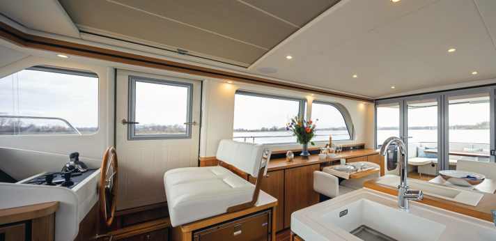 Below deck, light-coloured ceiling and wall panelling and upholstery give the rooms a friendly, inviting ambience.