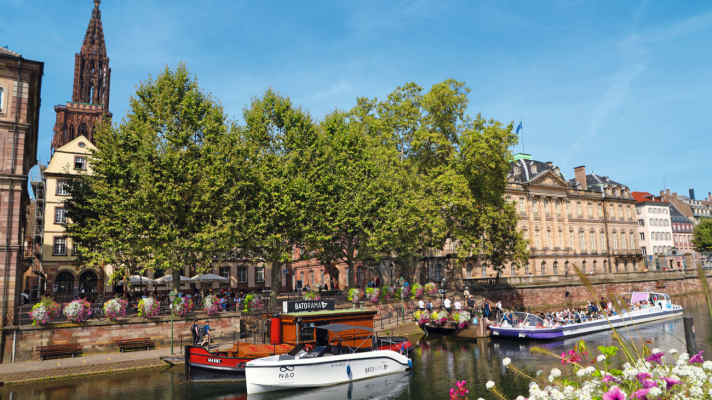 The River Ill in the centre of Strasbourg: the tower of the cathedral on the left, the riverside façade of the Palais Rohan on the right