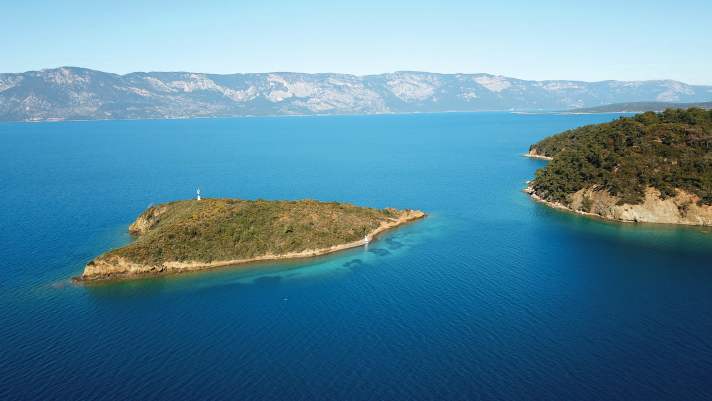   A tiny island deep in the Gulf of Gökova. A dinghy the size of a pinhead lies on the shore