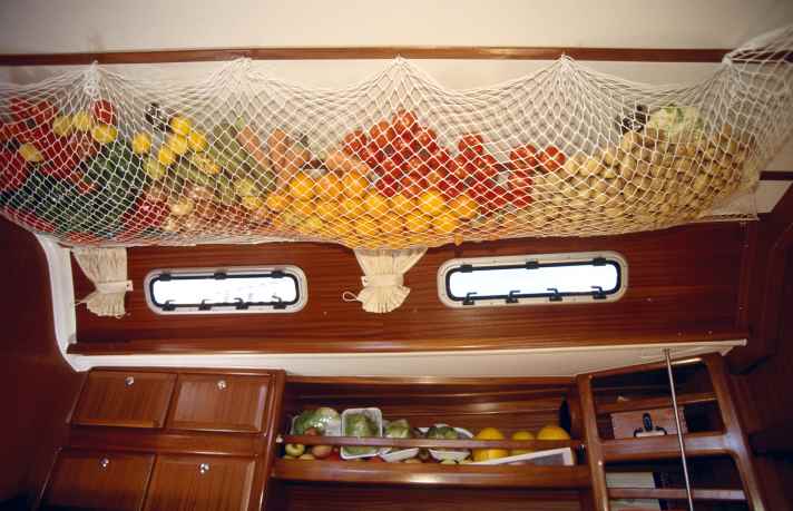 Fruit and vegetables inside of a net hanging from the ceiling of a saloon of a sailing ship which is prepared for the ARC (Atlantic Rally Cruise) leading from Las Palmas, Gran Canaria, Canary Islands, Spain to St.Lucia, Caribbean. ESP, 1999 | Fruit and vegetables inside of a net hanging from the ceiling of a saloon of a sailing ship which is prepared for the ARC (Atlantic Raly Cruise) leading from Las, Palmas, Gran Canaria, Canary Islands, Spain to St.Lucia, Caribbean. ESP, 1999 | [(c) Nicolai Krauss, Eichholz 21, 20459 H a m b u r g; Tel. +49-40-41919050; www.nico-krauss.de; E-Mail: mail@nico-krauss.de; Account: H a m b u r g e r S p a r k a s s e; Account no. 1237 473382; Sort code: 20050550; IBAN: DE 15 2005 0550 1237 4733 82 BIC HASPDE HH; Tax office Hamburg-Neustadt-St.Pauli; Tax number: 25/308/56235; www.freelens.com/clearing; Any use only against payment and receipt; if the photo is used for purposes other than journalism, please contact the photographer. No model release]. [#0,26,121#]