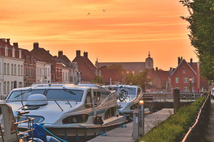    Mooring in Coupure harbour in Bruges, with St Walburga's Church behind it
