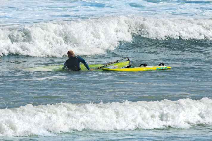 This allows you to push the sail top under water and hold the material in place until the wave has passed.
