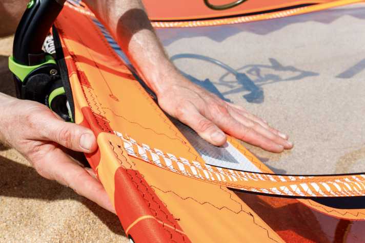 The batten above the boom extends too far beyond the mast - the sail has too little trim
