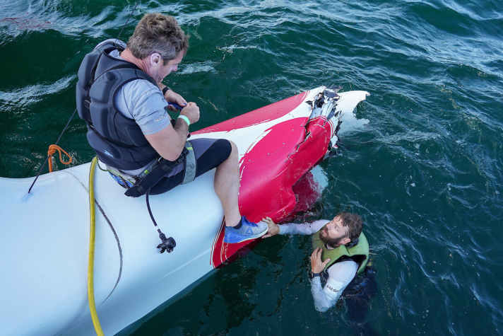 The Japanese team struggles to get its damaged boat into the harbour