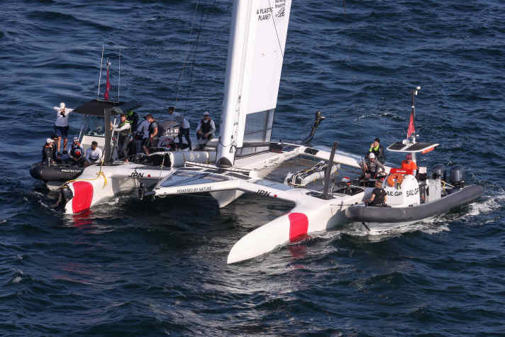 Helper boats secure the Japanese boat on its way to the harbour