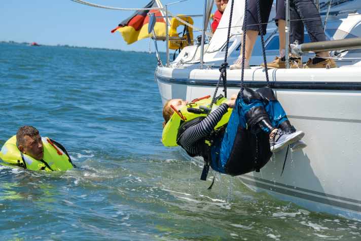 If the person is too weak or even unconscious, a crew member has to get into the water to pick them up or put an improvised rescue sling on them