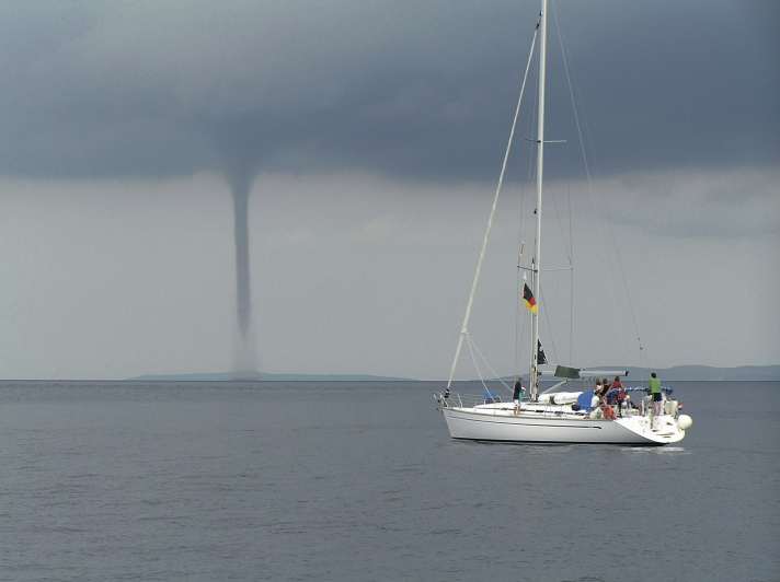   A crew in Croatia observes the formation of a waterspout from close up. The reason is strong updrafts of air heated by the water