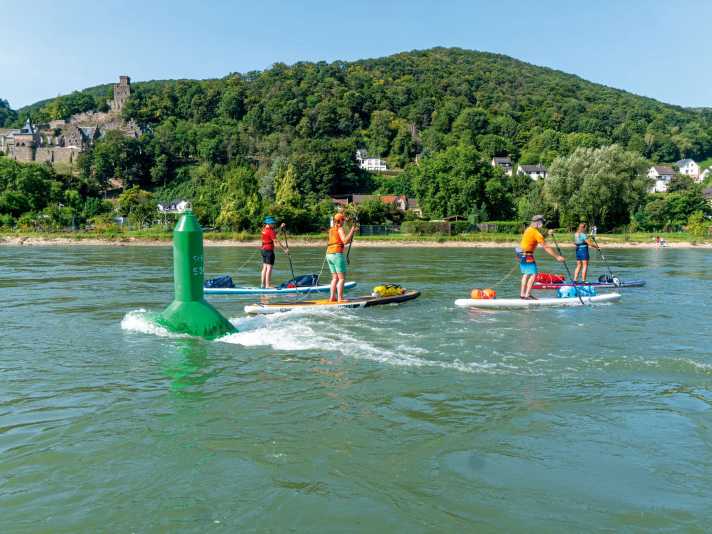 On federal waterways you should - if at all possible - paddle outside the navigation channel.  In other words, downstream to the left of the green buoys.