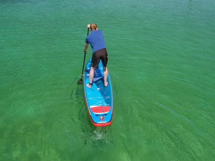 Correct: The paddle is guided towards the board.