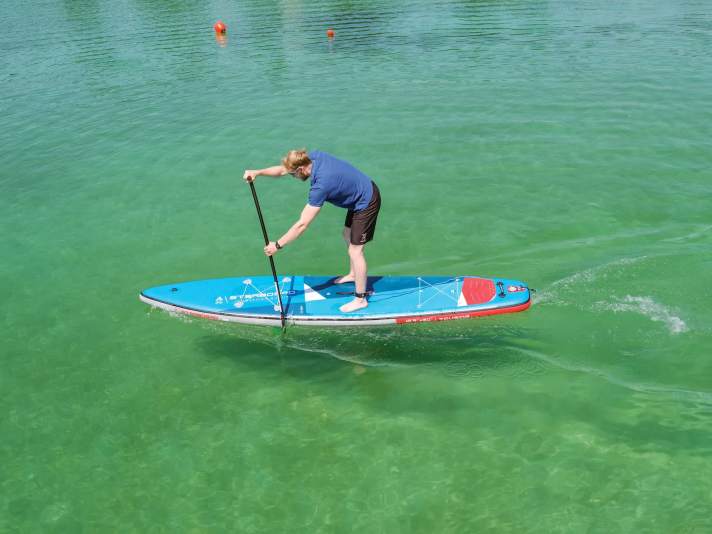 In order to have the longest possible pull phase, the lower arm should remain extended for a long time and the paddle should be dipped as far forward on the board as possible. To do this, the upper arm must also remain extended for a long time. Make sure that the arms are mainly stretched and that the upper body is not bent too far forwards.
bent too far forwards. This would reduce stability on the board and could possibly lead to back problems.
