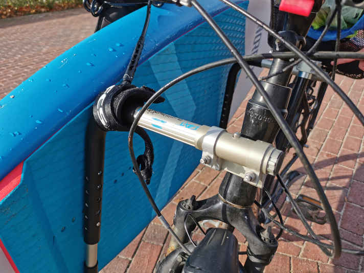 The longboard rack from Moved By Bikes sits on the side of the bike