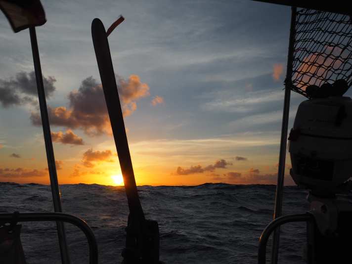   The sun rises behind the stern