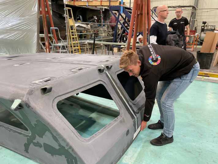   Will Harris hebt mit nur einer Hand die achtere Kanzel des Cockpits an. Sie ist extrem leicht und wichtig für den obligatorischen Kentertest