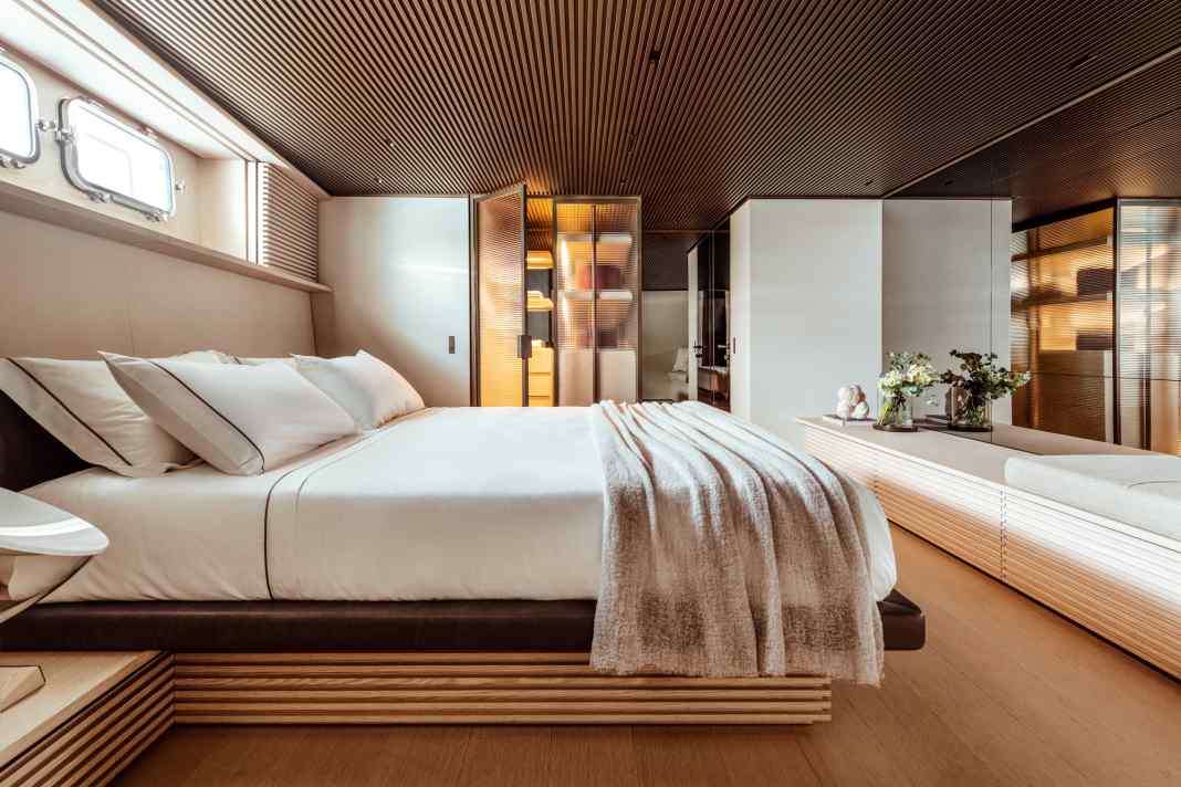 Owner's cabin: warm light streams out of the wardrobe through ribbed glass doors. Mirrors and wooden louvres extend the length of the room