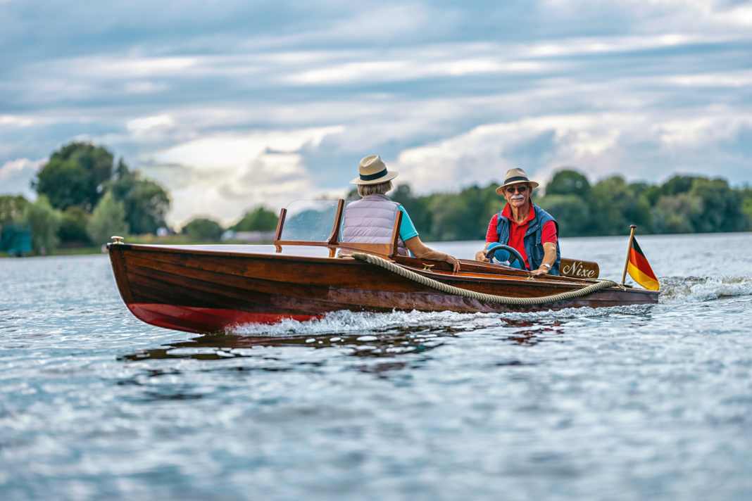 Owner Menno Wolters at the helm of his "Nixe" during a trip on the Dove-Elbe near Hamburg