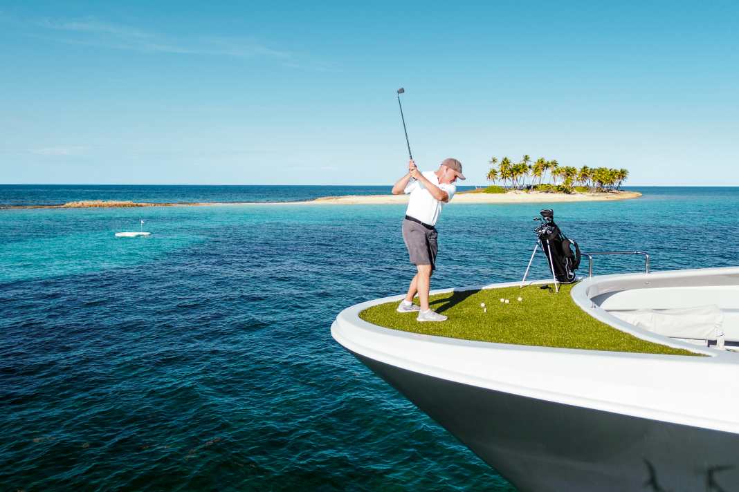 Wide field: "Gene Machines" First Engineer tries to hit the green in the blue in the Bahamas.  If the ball lands in the liquid bunker, it dissolves and becomes fish food