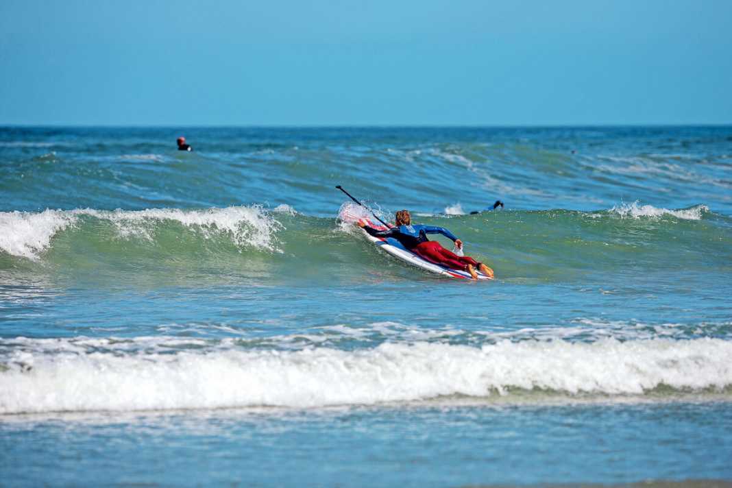 In extremely choppy water within the surf zone, lying down is often the only thing that helps. The paddle lies under the body and you paddle with the bow out towards the wave with your hands.