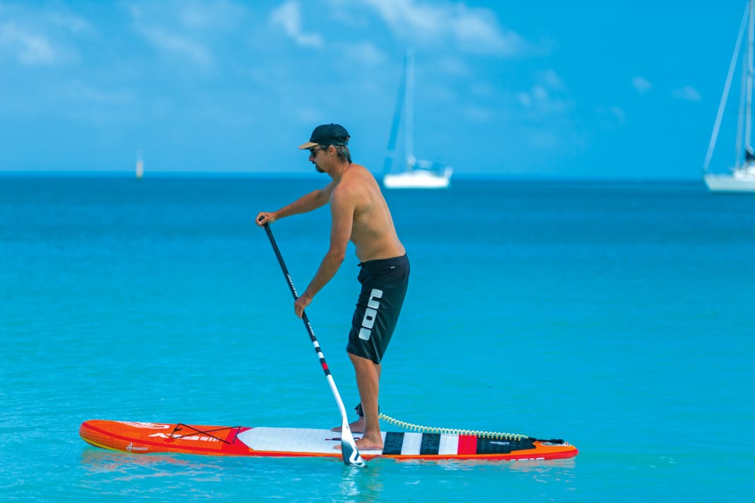 You pull the paddle out at the level of your feet or slightly in front of them, but not behind them, otherwise you switch to so-called negative paddling, which slows you down, destabilises you and can damage your back in the long run