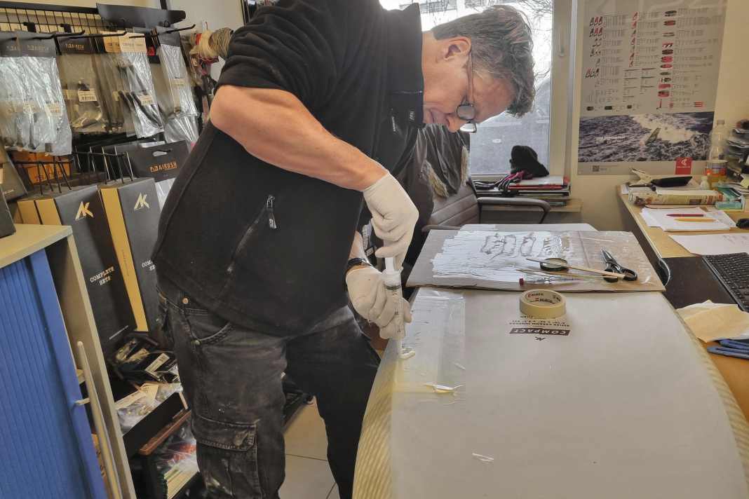 A real surfer's office: Sven Grunwald, from AK and Starboard in Germany, turns the desk into an operating table.