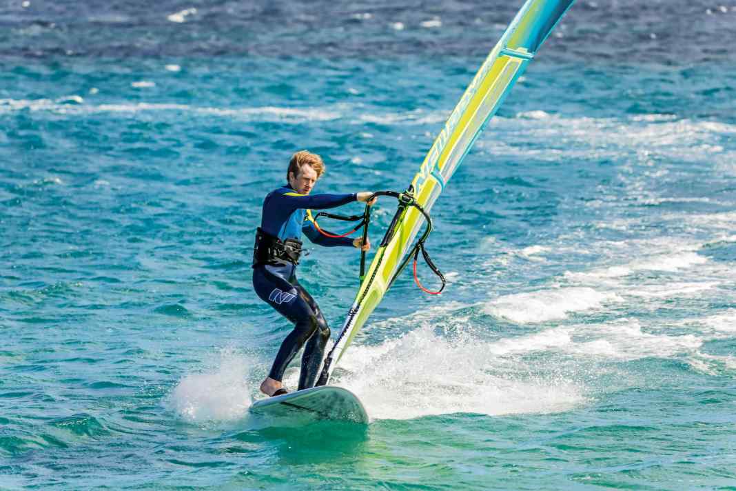 You initiate a leeward turn by moving the back foot out of the strap towards the leeward edge
