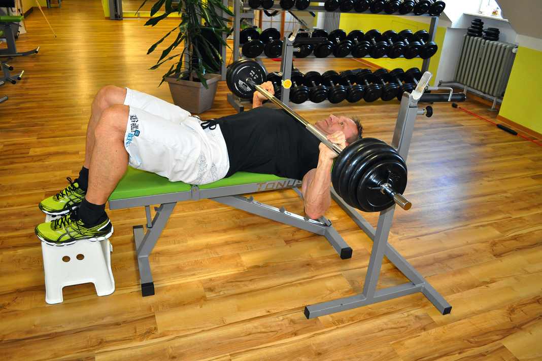 Bench press: Grip the barbell well above shoulder width and then slowly lower it to your chest.