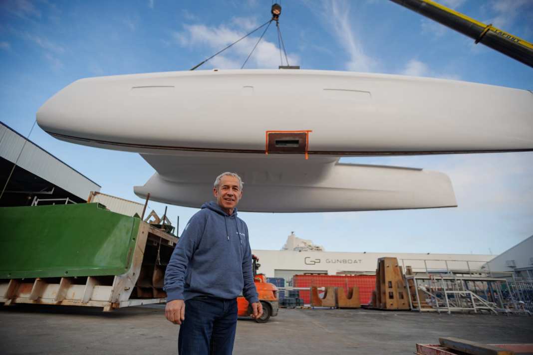 The hull of Jourdain's Outremer 5X hangs in the crane.